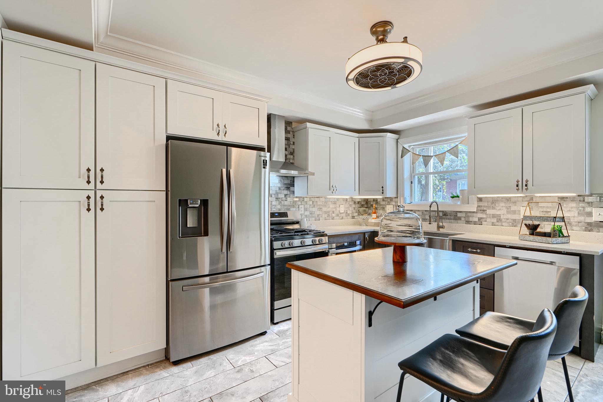 119 South Potomac Street Baltimore, MD 21224 - Photo 4 of 26 a kitchen with stainless steel appliances granite countertop a stove refrigerator sink and cabinets