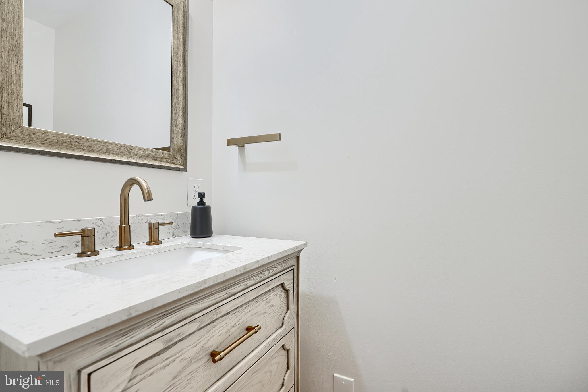 119 South Potomac Street Baltimore, MD 21224 - Photo 6 of 26 a bathroom with a sink and a mirror