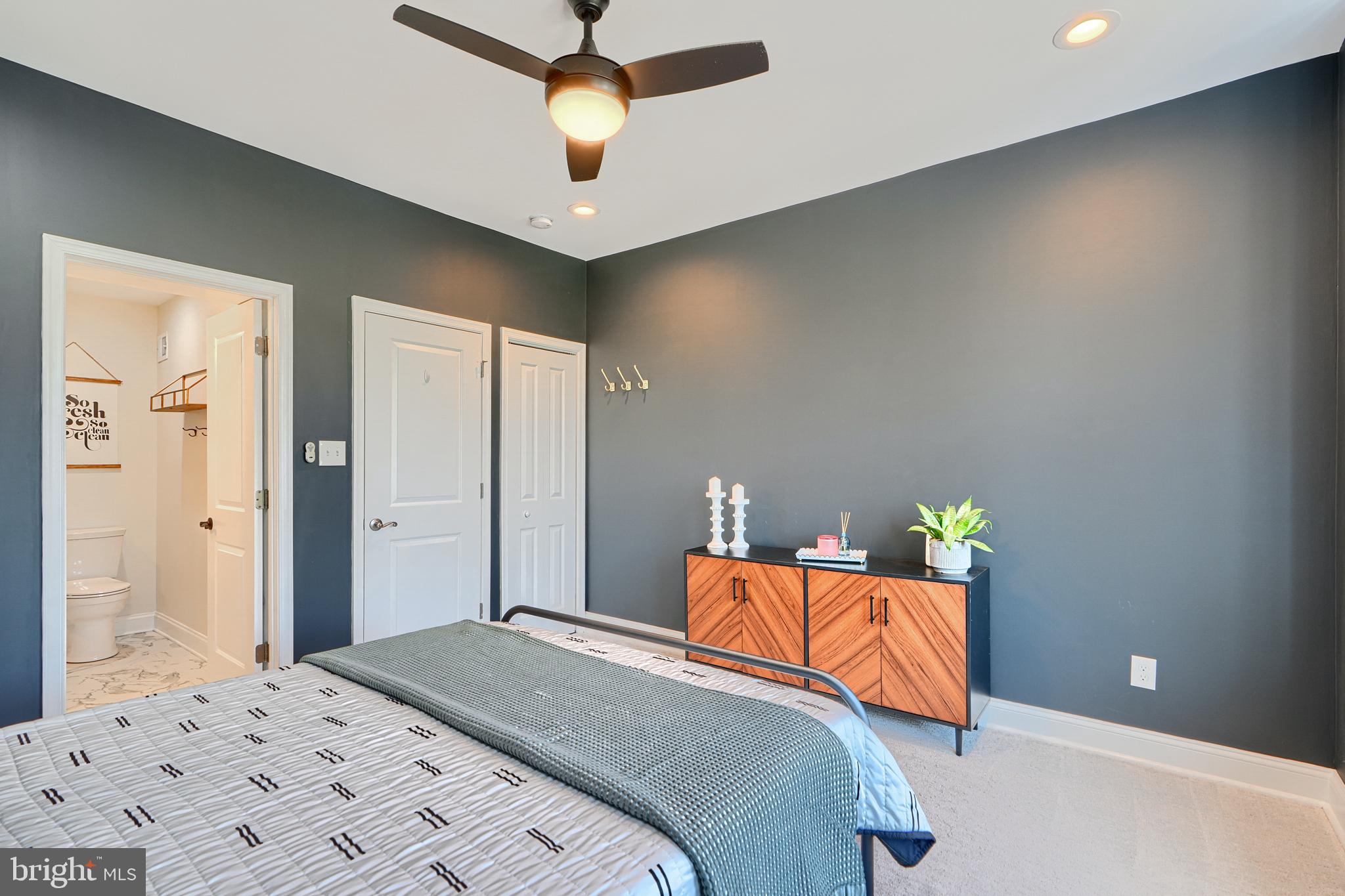 119 South Potomac Street Baltimore, MD 21224 - Photo 9 of 26 a bedroom with a bed and a chandelier