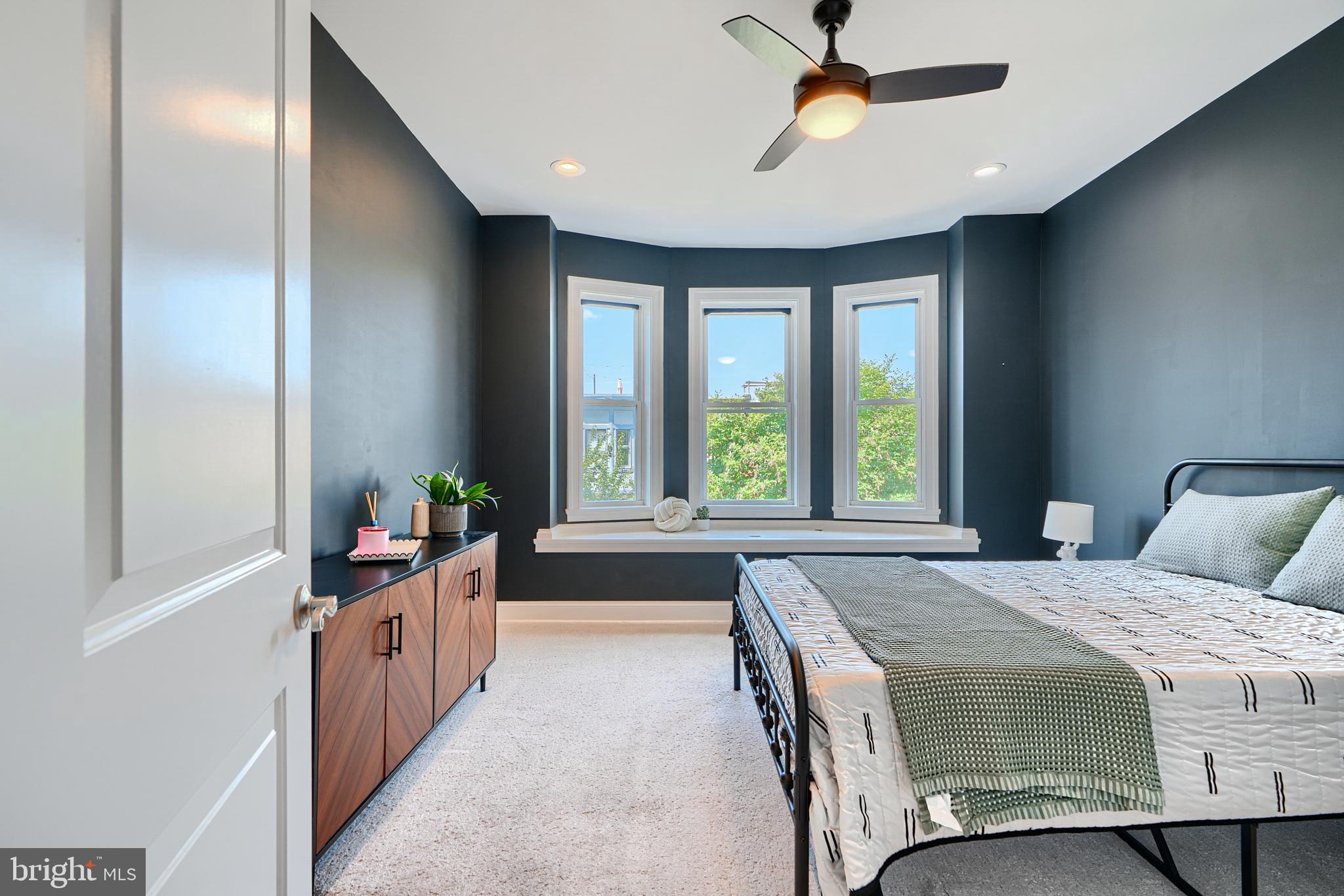 119 South Potomac Street Baltimore, MD 21224 - Photo 10 of 26 a bedroom with a bed and a chandelier