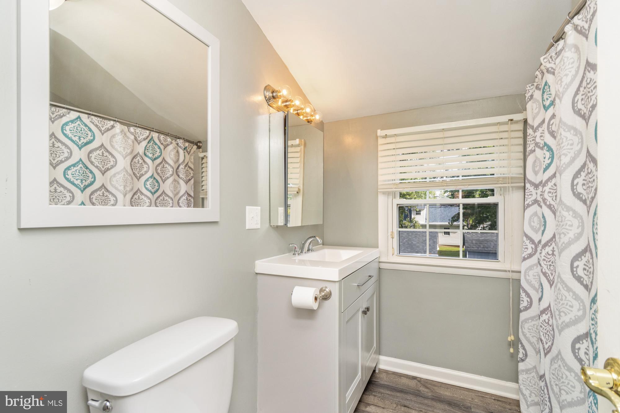 944 Homberg Avenue Baltimore, MD 21221 - Photo 26 of 50 a bathroom with a toilet sink and mirror
