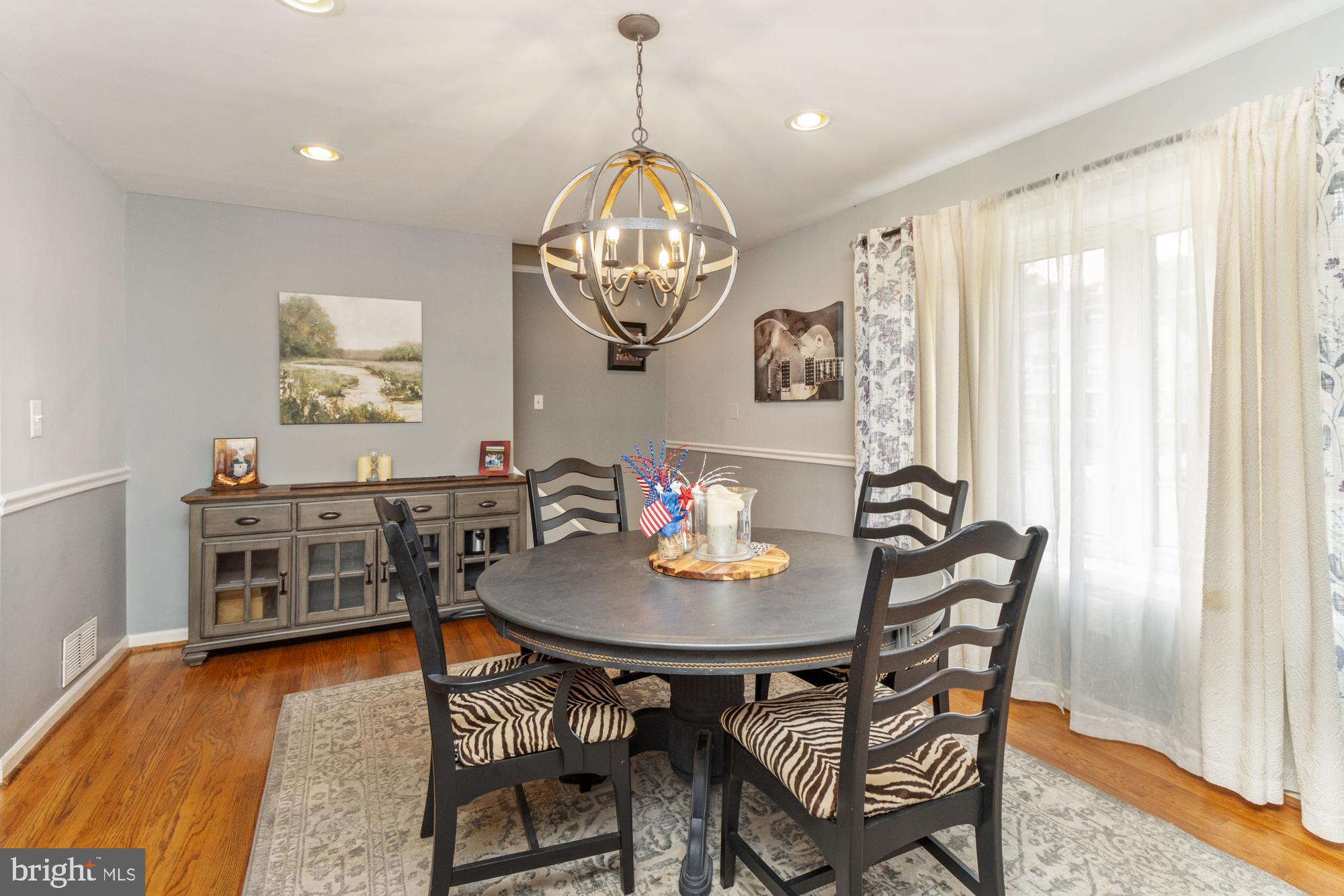 944 Homberg Avenue Baltimore, MD 21221 - Photo 9 of 50 a view of a dining room with furniture wooden floor and a chandelier