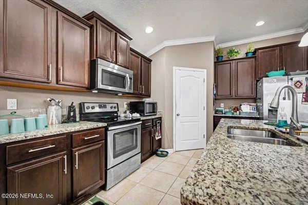 a kitchen with wooden cabinets and a stove top oven