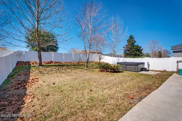 a view of a house with a yard and potted plants