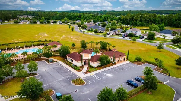 an aerial view of a house with a swimming pool outdoor seating and yard