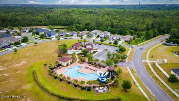 a view of a swimming pool in he middle of the green field
