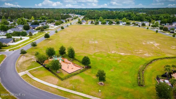 an aerial view of a swimming pool with outdoor seating