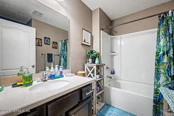 a bathroom with a sink a mirror and a shower