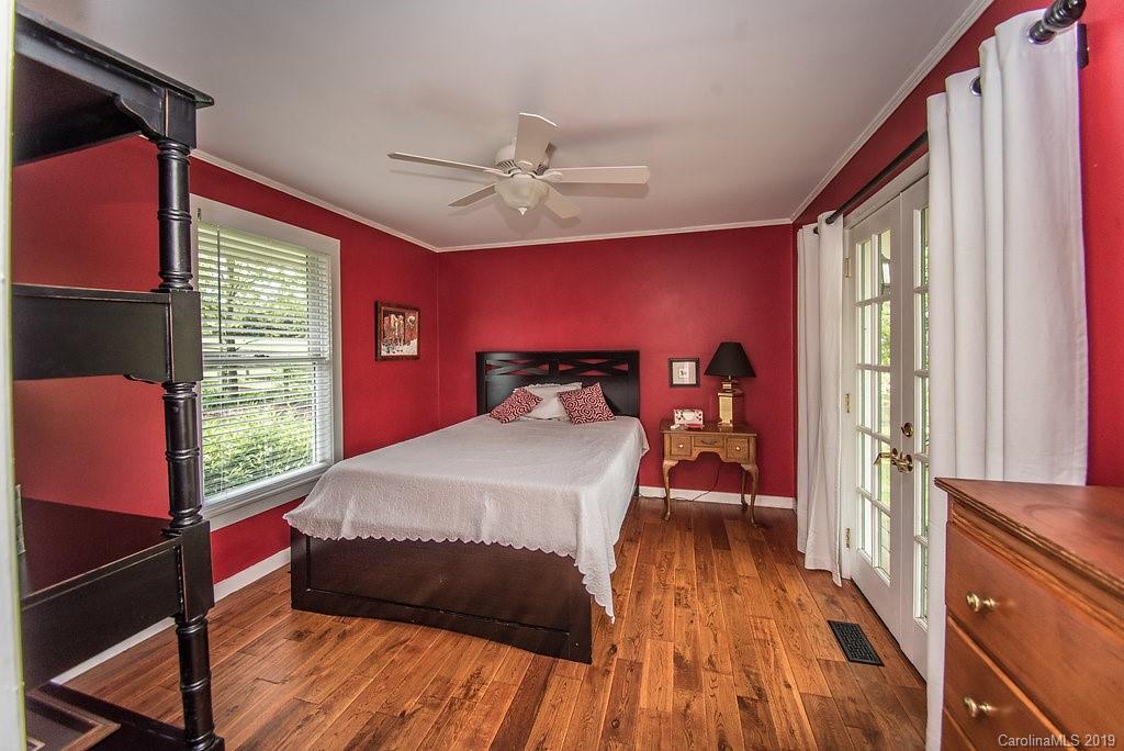 435 Landrum Road Columbus, NC 28722 - Photo 11 of 22 a bedroom with a bed and wooden floor