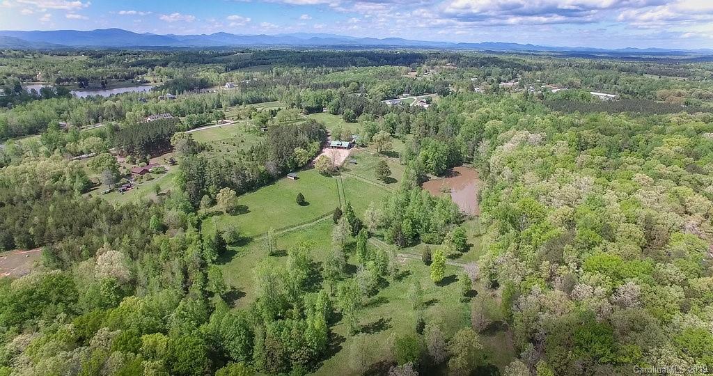 435 Landrum Road Columbus, NC 28722 - Photo 22 of 22 a view of a lush green forest with trees and some houses