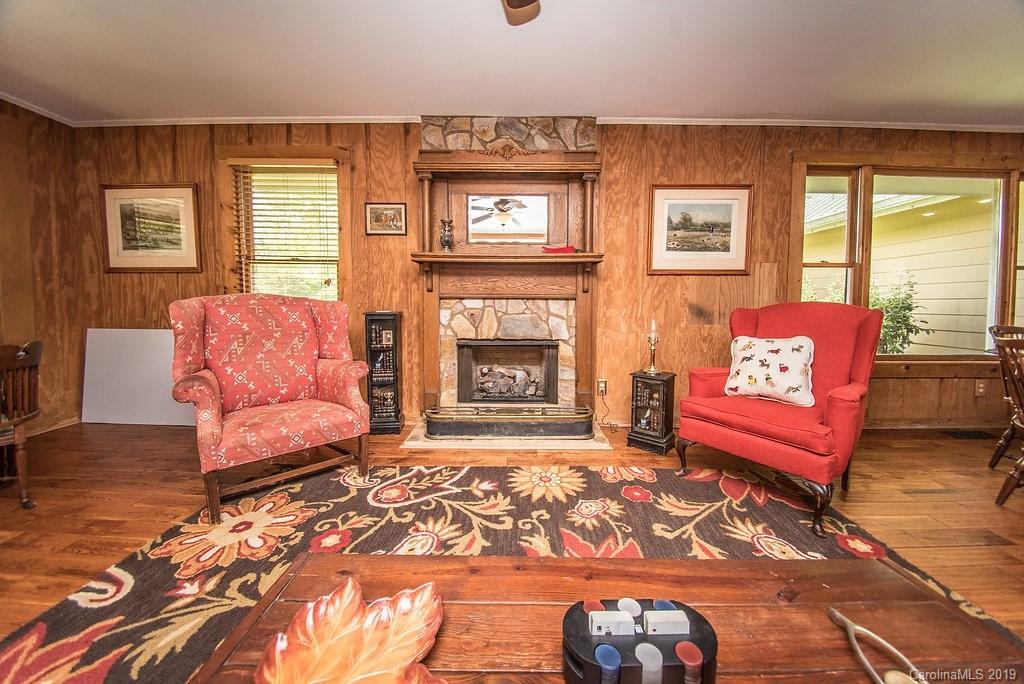 435 Landrum Road Columbus, NC 28722 - Photo 4 of 22 a living room with furniture and a fireplace