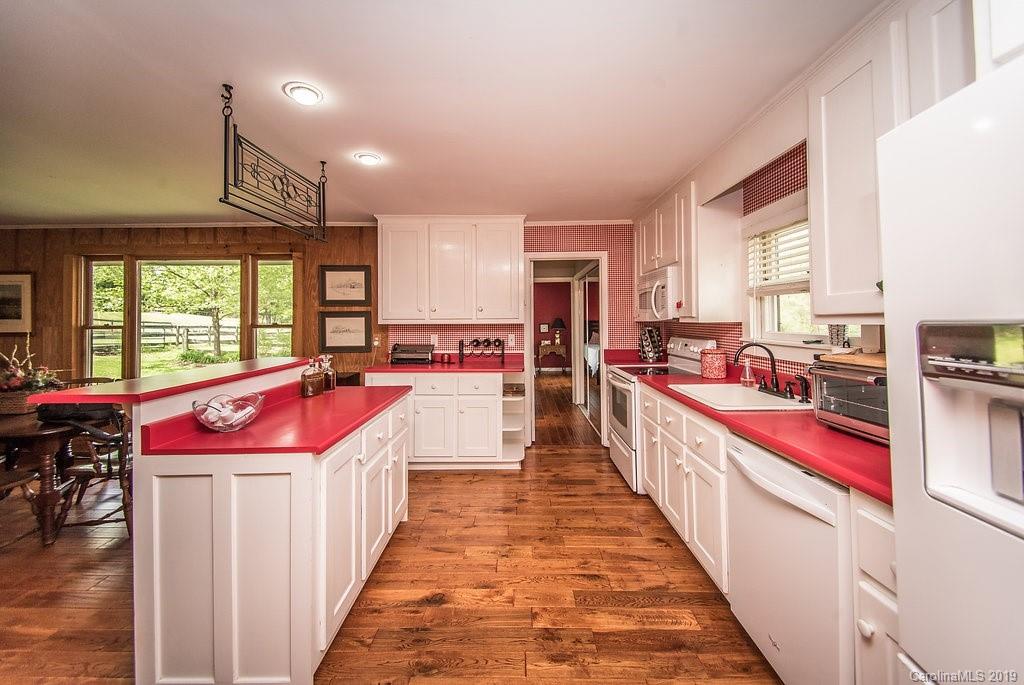 435 Landrum Road Columbus, NC 28722 - Photo 5 of 22 a kitchen with kitchen island granite countertop lots of counter top space and wooden floor