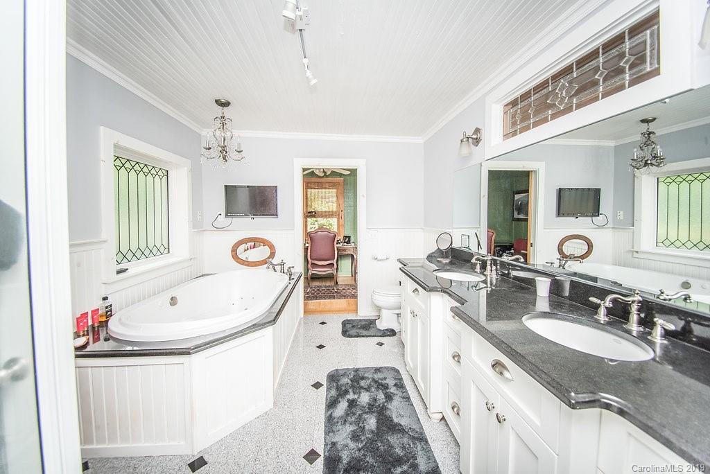 435 Landrum Road Columbus, NC 28722 - Photo 9 of 22 a large white kitchen with a sink large mirror and a bathtub