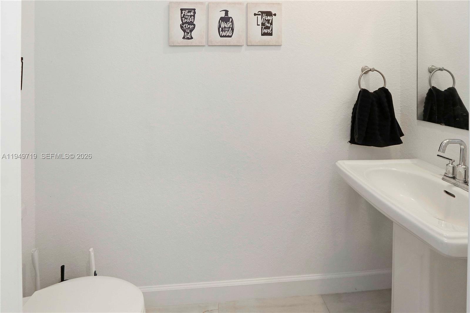 2432 Southeast 10th Street Homestead, FL 33035 - Photo 12 of 30 a bathroom with a toilet sink and mirror
