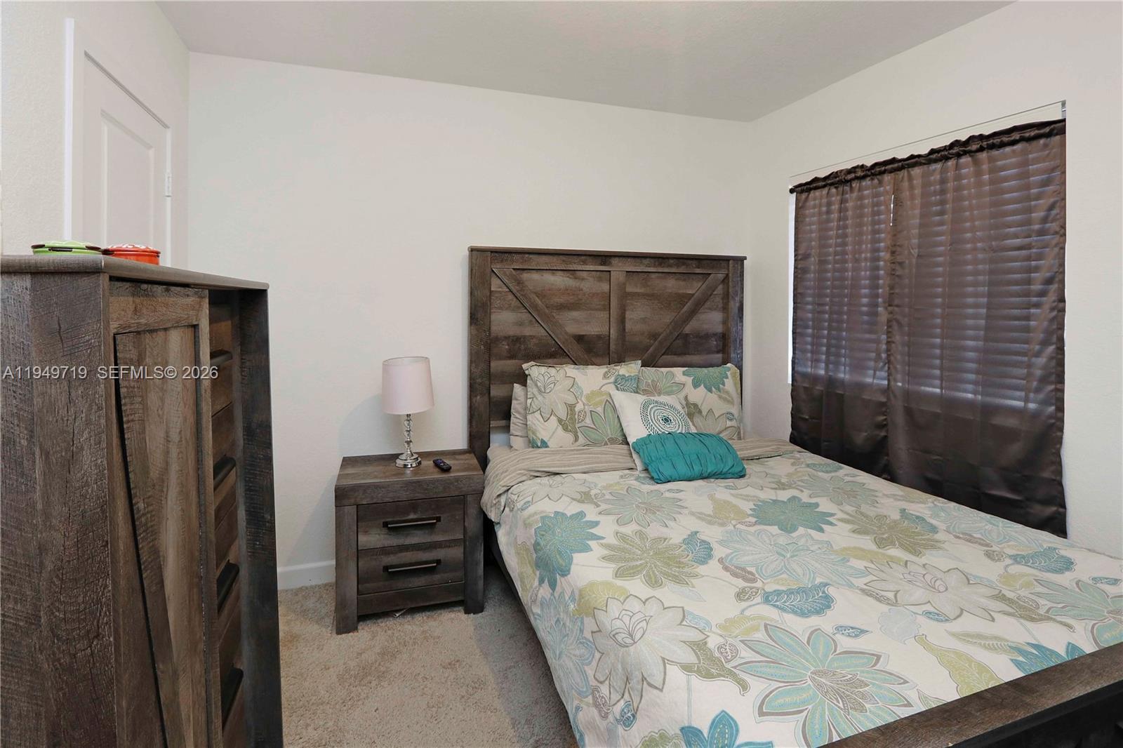 2432 Southeast 10th Street Homestead, FL 33035 - Photo 16 of 30 a bedroom with a bed and a dresser