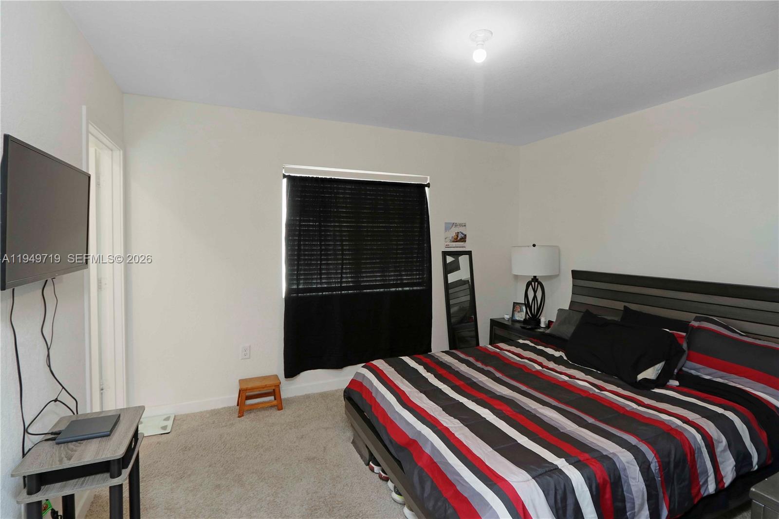2432 Southeast 10th Street Homestead, FL 33035 - Photo 19 of 30 a bedroom with a bed and dresser