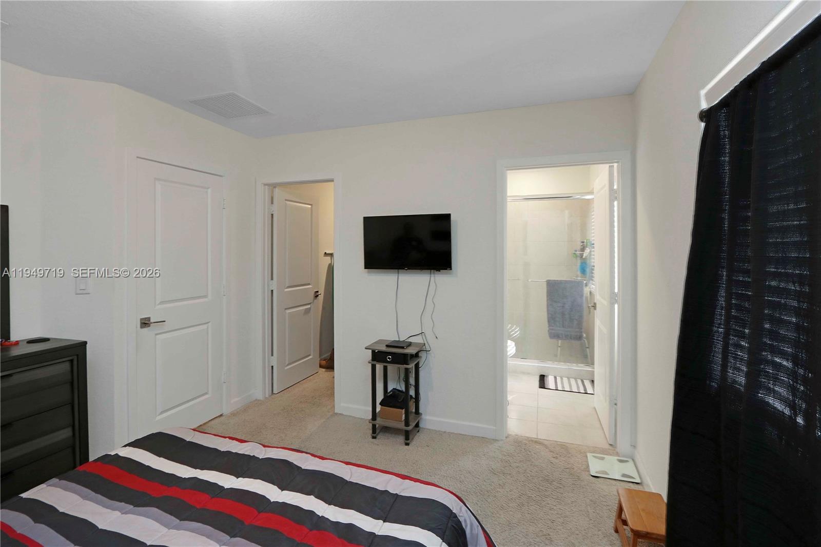 2432 Southeast 10th Street Homestead, FL 33035 - Photo 20 of 30 a bedroom with a bed and a flat screen tv