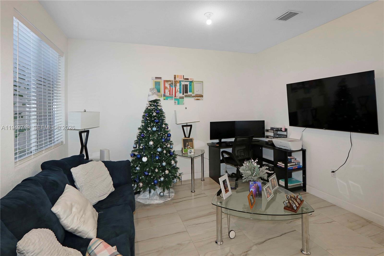 2432 Southeast 10th Street Homestead, FL 33035 - Photo 3 of 30 a living room with furniture and a flat screen tv