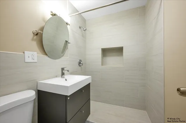 a bathroom with a sink toilet and a mirror