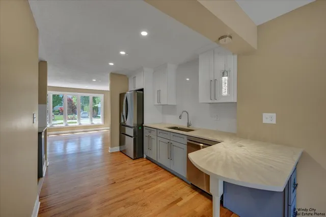 a kitchen with refrigerator cabinets and wooden floor
