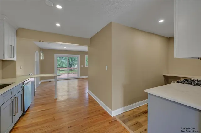 a view of a kitchen with wooden floor and a sink