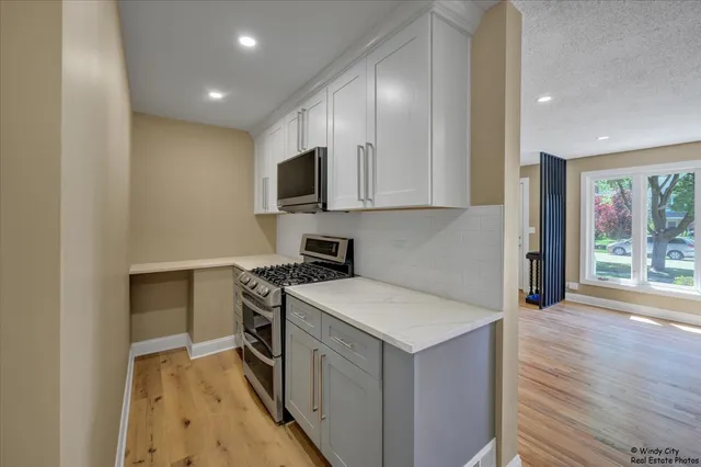 a kitchen with a sink stove and microwave