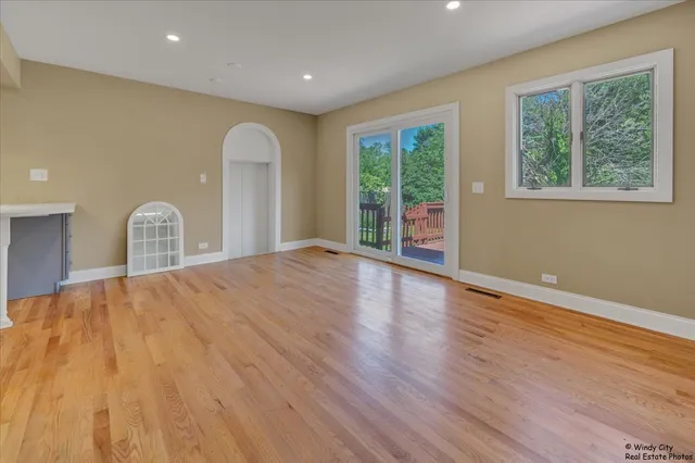 a room with wooden floor and a window
