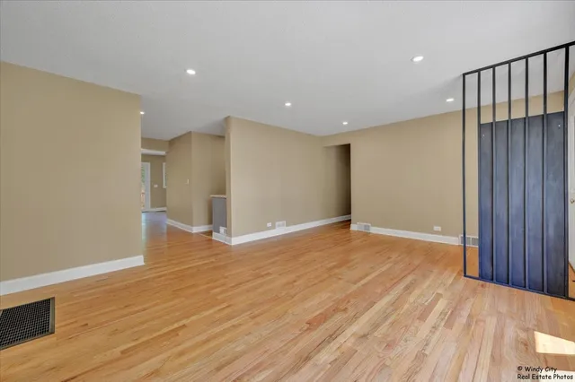 a view of empty room with wooden floor