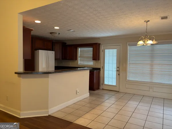 a view of a kitchen with a sink and a refrigerator