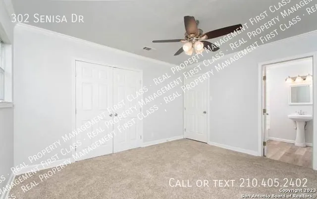 a view of a hallway with a chandelier fan and entryway