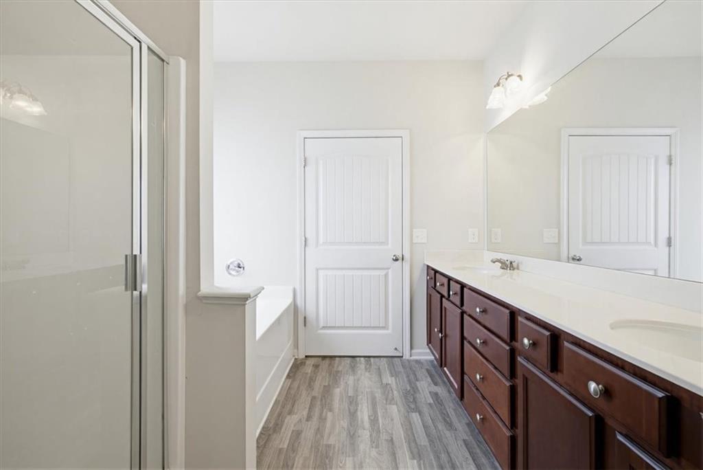 314 Boulder Run Hiram, GA 30141 - Photo 21 of 31 a bathroom with a sink a mirror and a shower