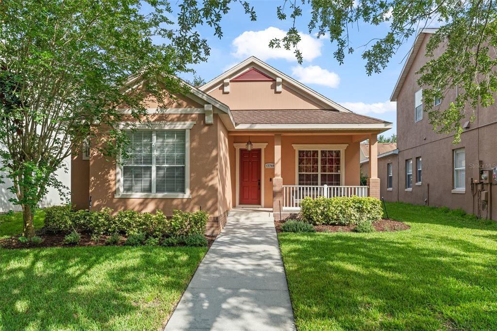 13768 Bluebird Pond Road Windermere, FL 34786 - Photo 1 of 1 a front view of a house with garden