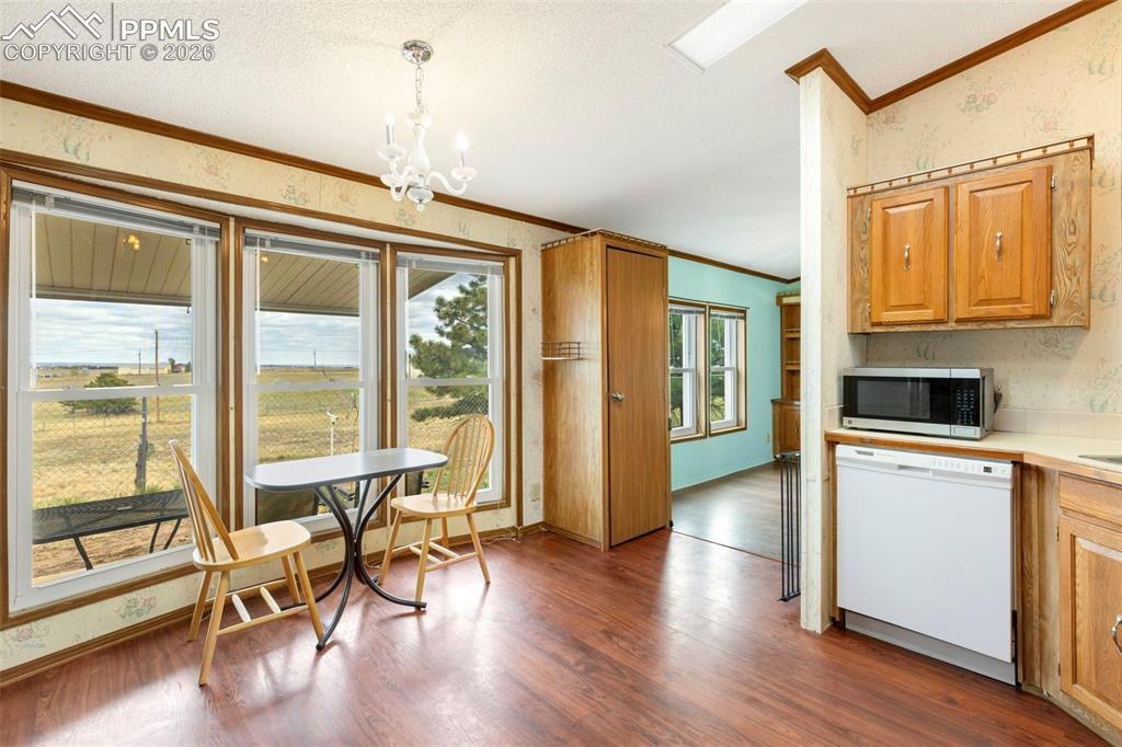 13335 Gymkhana Road Peyton, CO 80831 - Photo 21 of 38 Bright dining area featuring a trio of large windows with expansive outdoor scenery