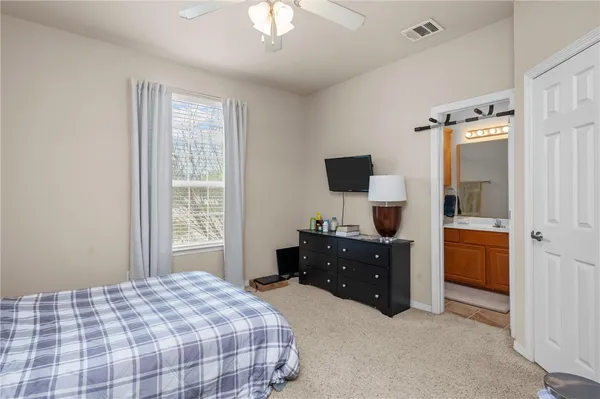 a bedroom with a bed and a flat tv screen