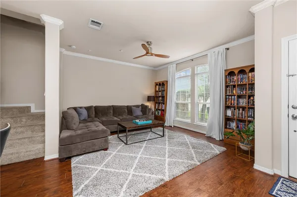a living room with furniture and a book shelf