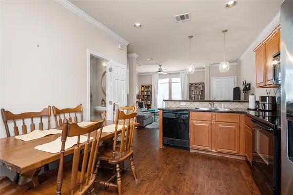 a large kitchen with a table and chairs