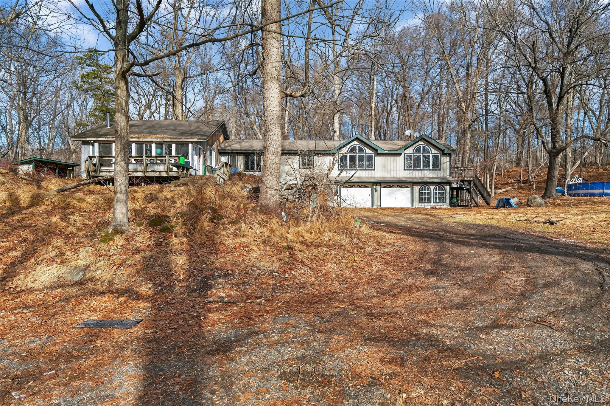 a front view of a building with large trees