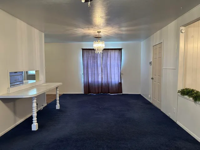 wooden floor and chandelier in a room