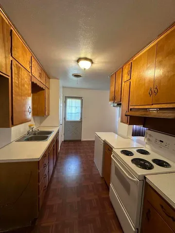 a kitchen with a stove and a sink
