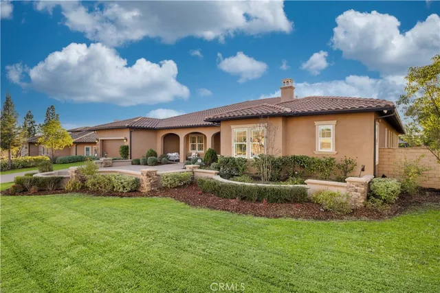 a front view of a house with a garden and plants
