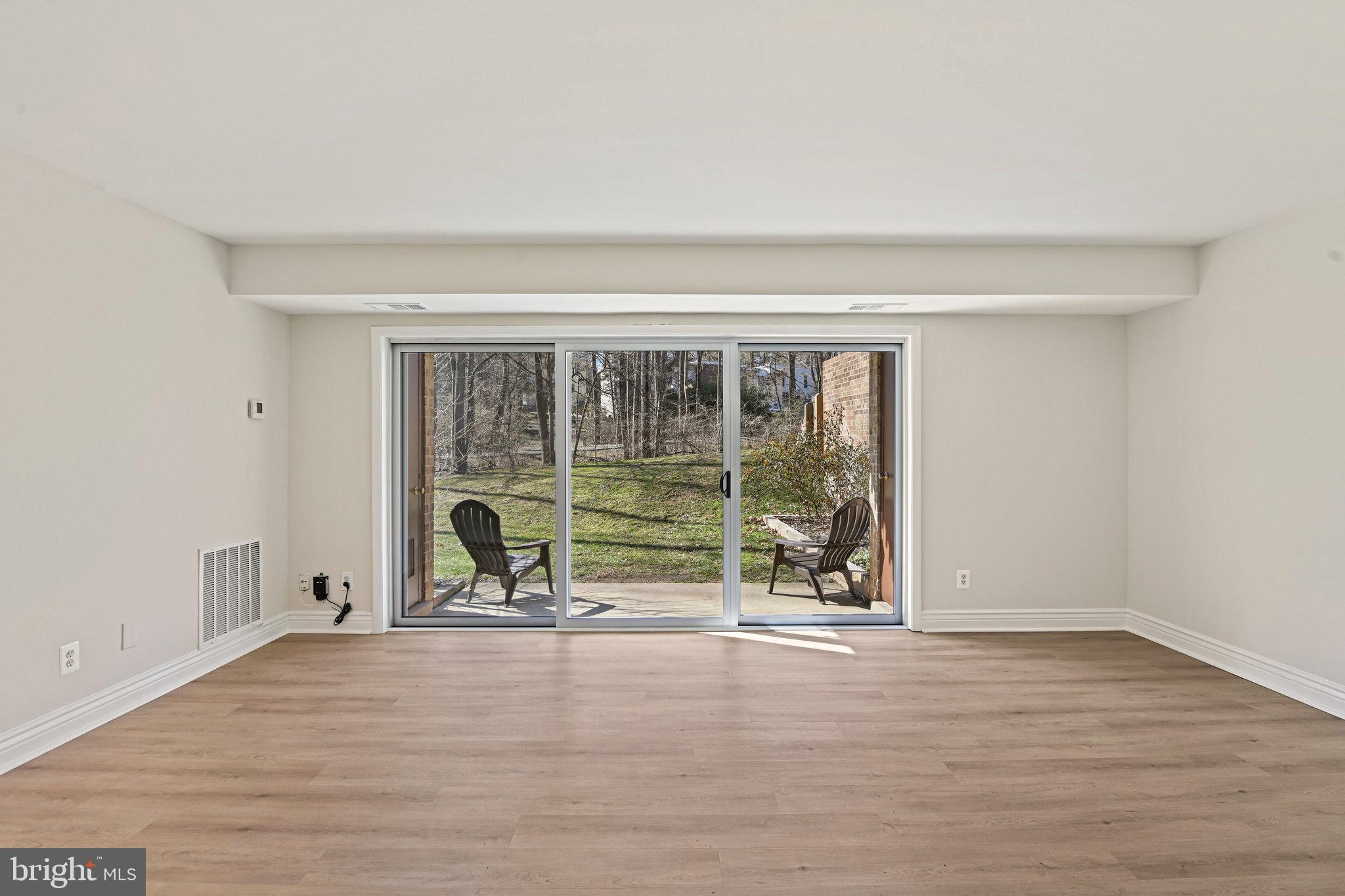 11625 Vantage Hill Road, Unit C Reston, VA 20190 - Photo 6 of 35 a view of empty room with wooden floor and windows