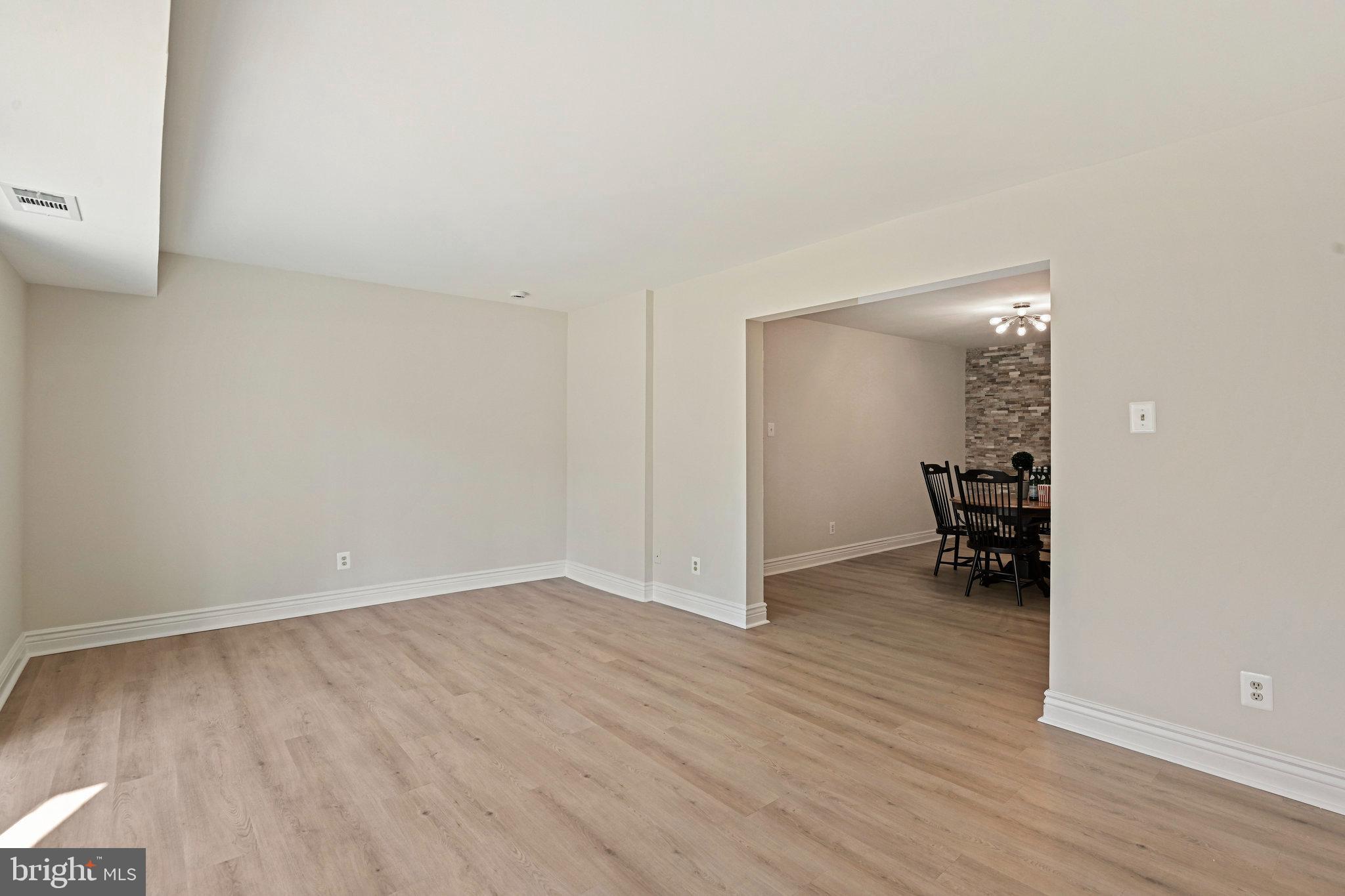 11625 Vantage Hill Road, Unit C Reston, VA 20190 - Photo 8 of 35 a view of empty room with wooden floor and bathroom view