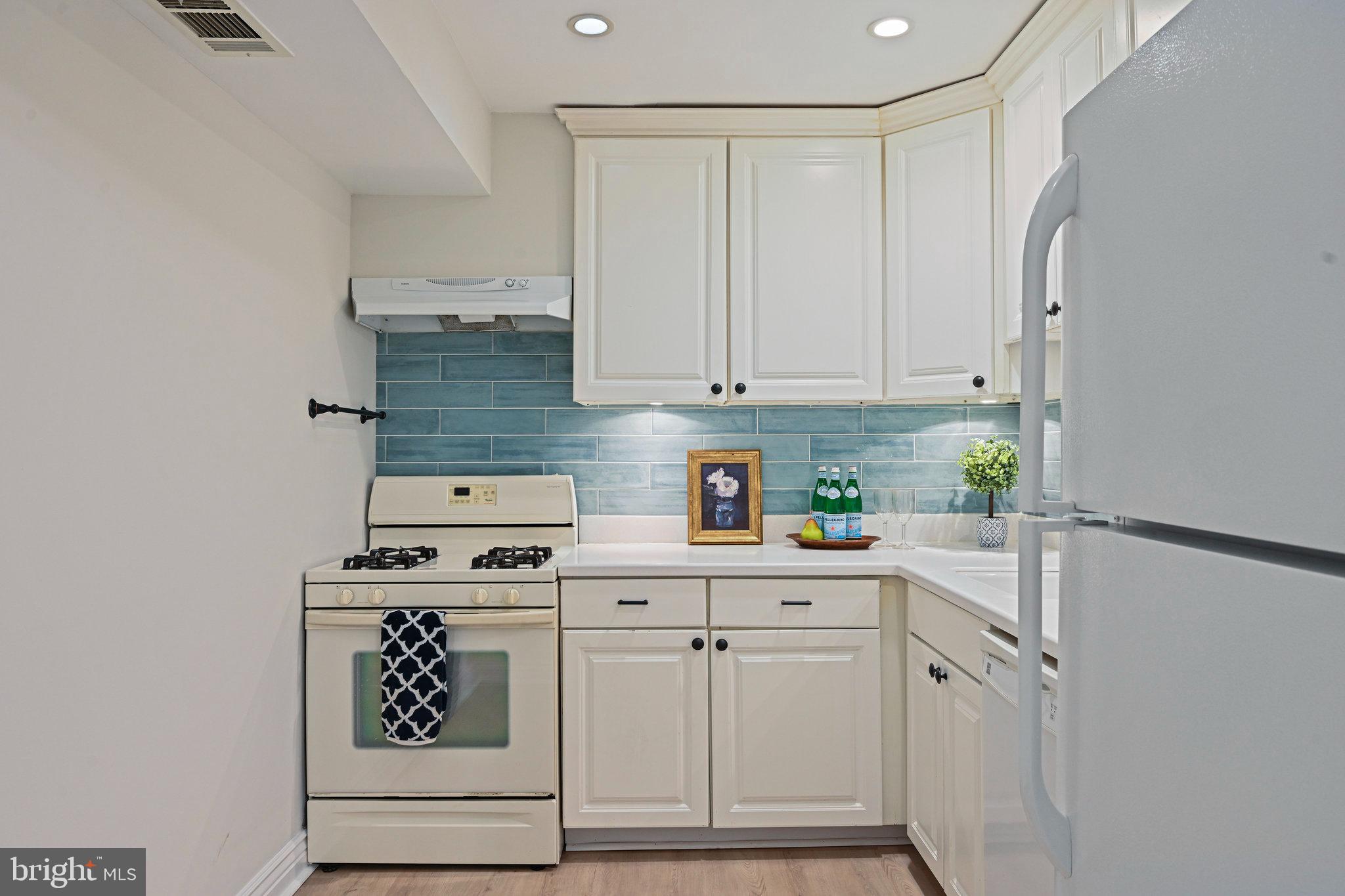 11625 Vantage Hill Road, Unit C Reston, VA 20190 - Photo 9 of 35 a kitchen with white cabinets and white appliances
