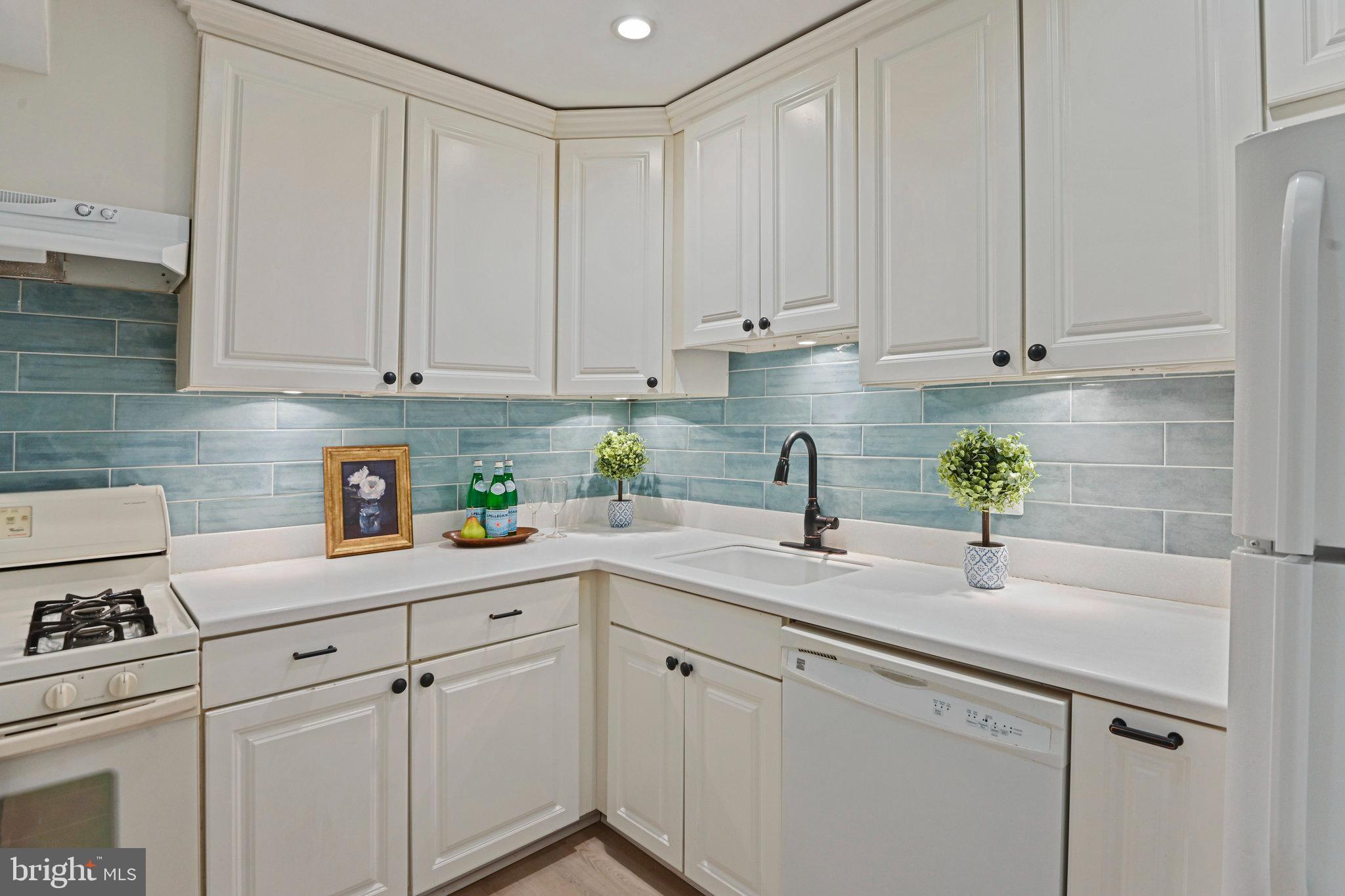 11625 Vantage Hill Road, Unit C Reston, VA 20190 - Photo 10 of 35 a kitchen with white cabinets and white appliances