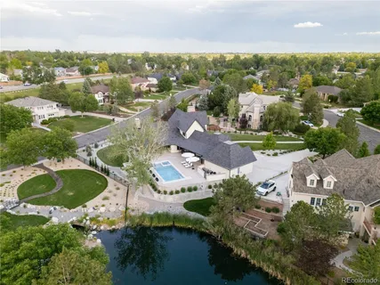 an aerial view of residential houses with outdoor space and river