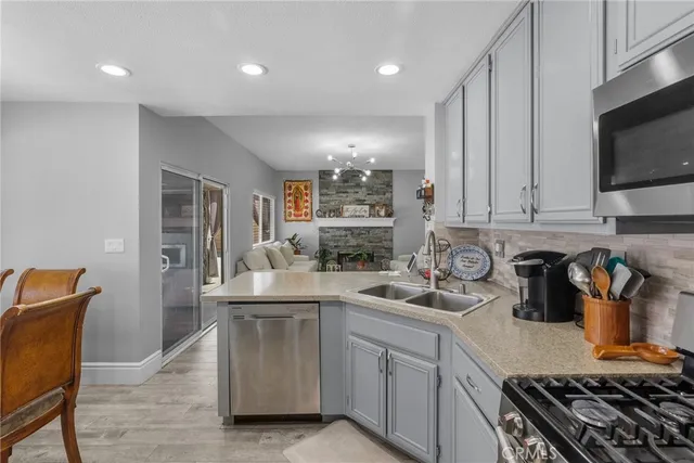 a kitchen with stainless steel appliances granite countertop a stove and a sink