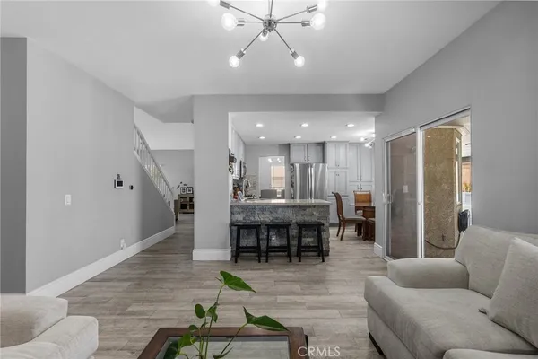 a living room with furniture and kitchen view