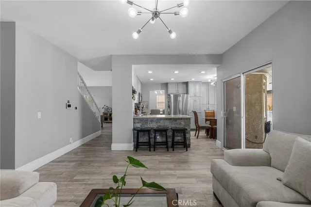 a living room with furniture and kitchen view
