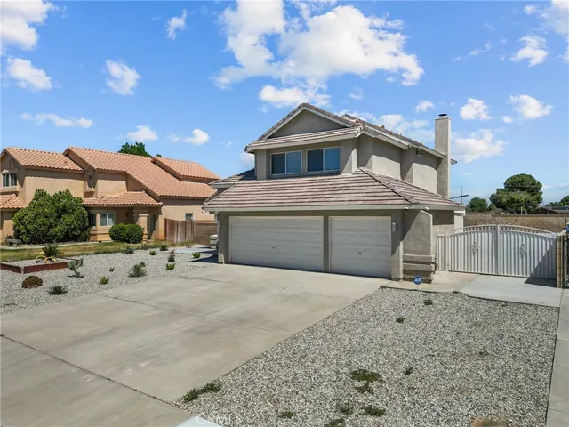 a view of a house with a wooden fence