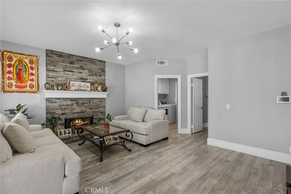 a living room with furniture and a fireplace